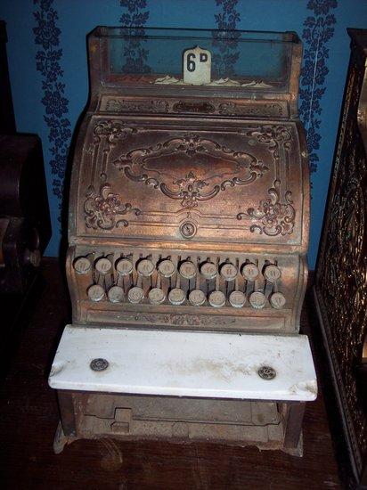 Appraisal: A gilt metal cash register numbered the hinged lid and