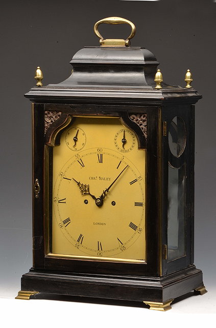 Appraisal: A GEORGE III EBONISED BRACKET CLOCK the ogee shaped top