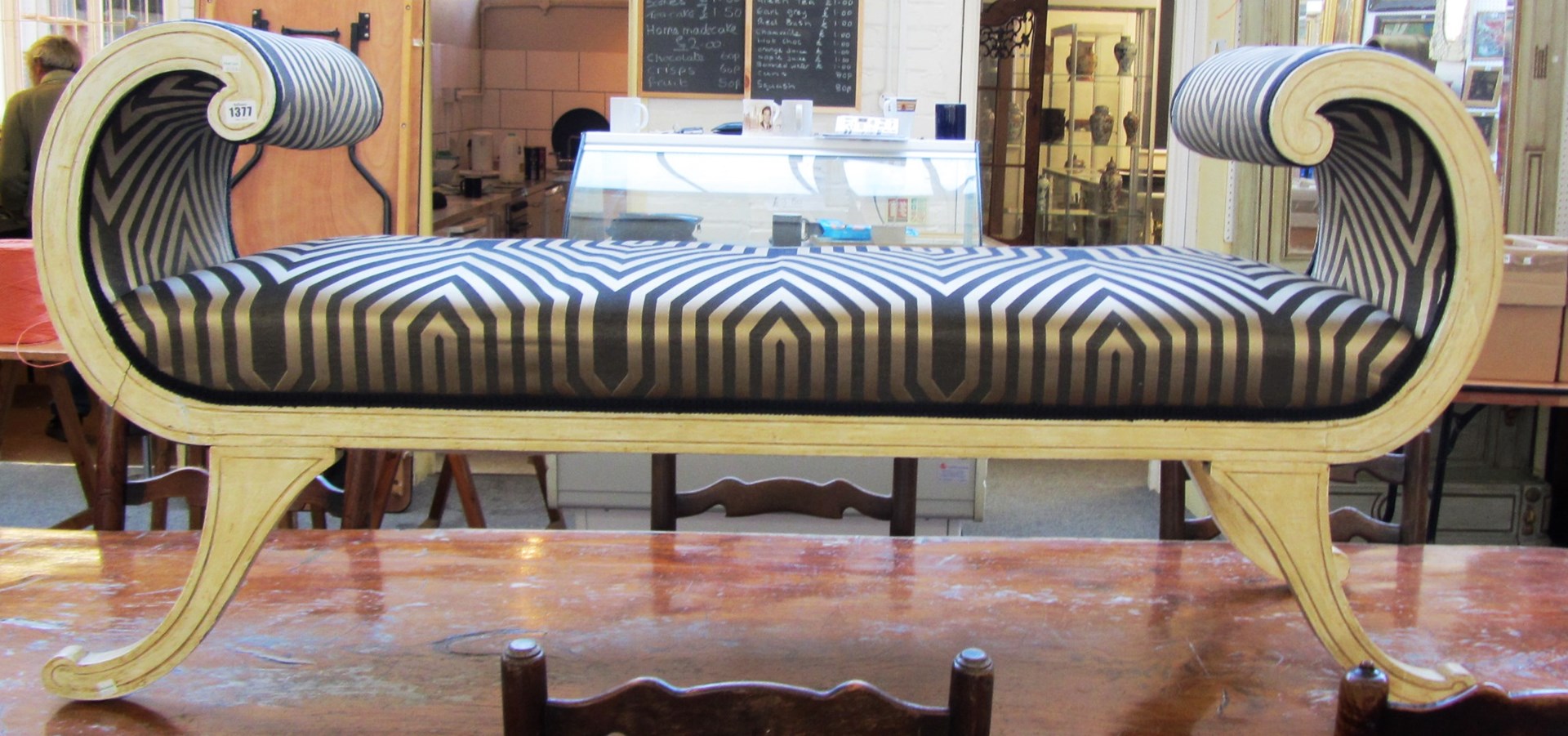 Appraisal: A Regency design painted window seat with scroll arms and