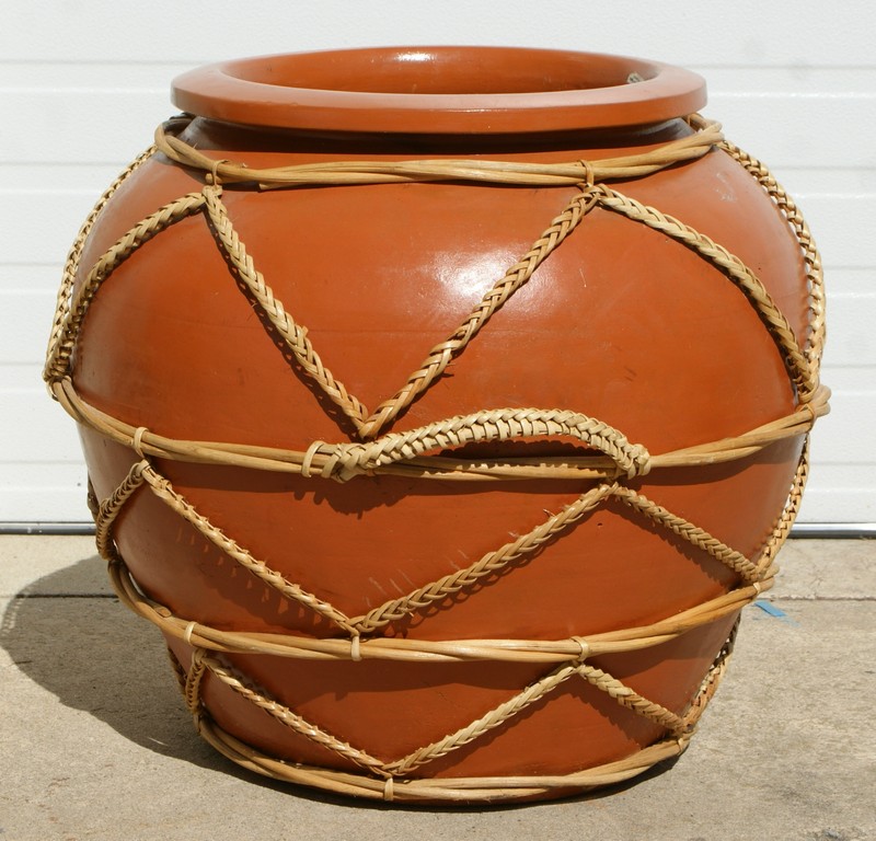 Appraisal: Large Terracotta planter with hand hewn bamboo applique h diameter