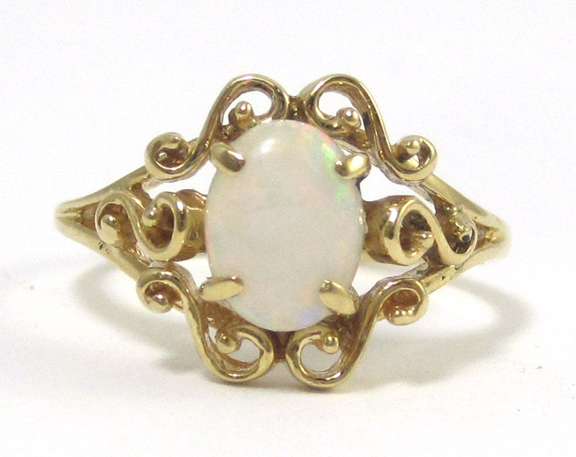 Appraisal: OPAL AND FOURTEEN KARAT GOLD RING featuring an oval opal