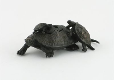 Appraisal: A small Japanese bronze incense burner and cover formed as