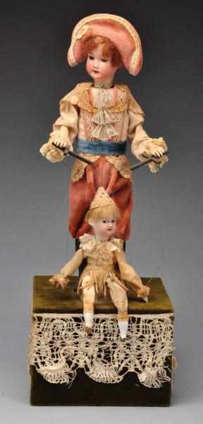 Appraisal: Child Playing with Marionette Automaton Description Both dolls have antique