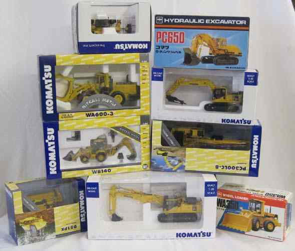 Appraisal: NINE DIECAST SCALE MODELS OF KOMATSU HEAVY EQUIPMENT including Shinsei