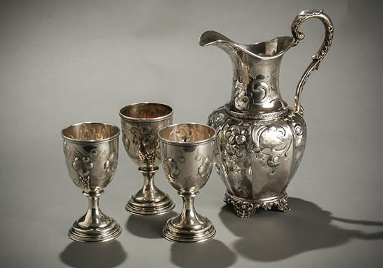 Appraisal: American Repouss Silver Water Pitcher and a Set of Three