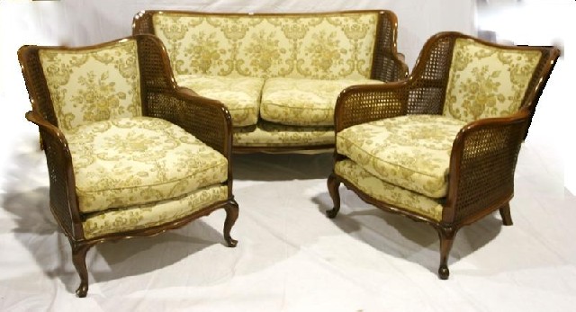 Appraisal: A stained beech caned and upholstered three piece lounge suite