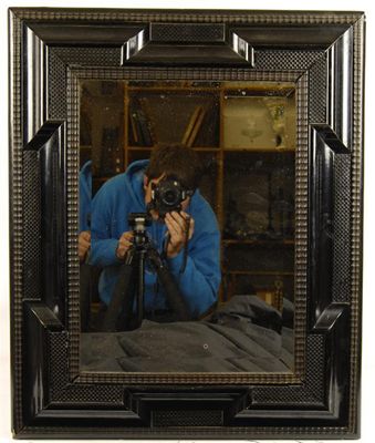 Appraisal: A Flemish ebonised rectangular wall mirror with a bevelled plate