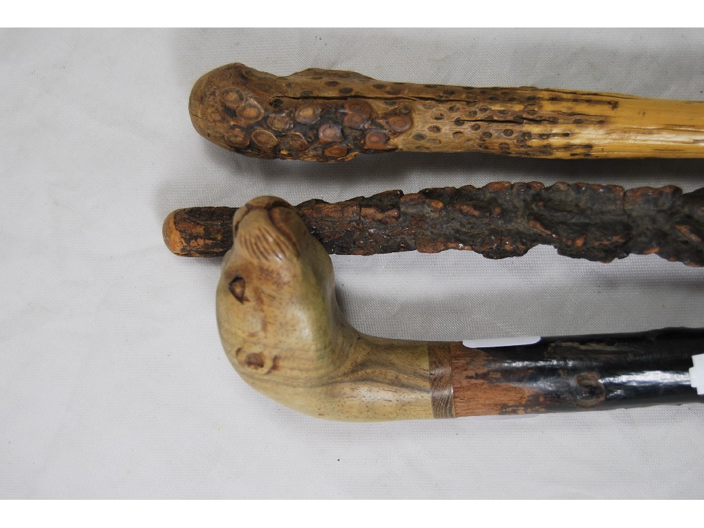 Appraisal: A hazel walking cane the pommel carved as an otter's