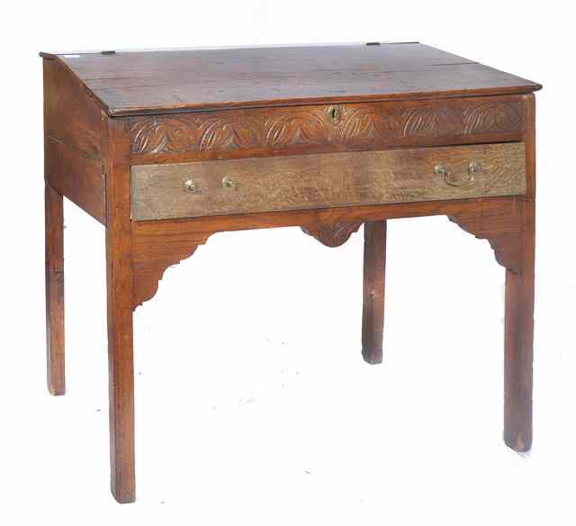 Appraisal: AN ANTIQUE OAK DESK with hinged fall front chip carved