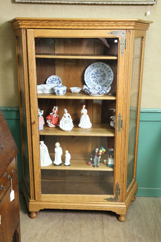 Appraisal: CHINA CABINET Oak with a molded cornice glazed and canted