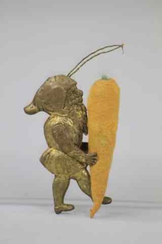 Appraisal: ELF CARRYING CARROT DRESDEN ORNAMENT Germany Dresden elf carrying a