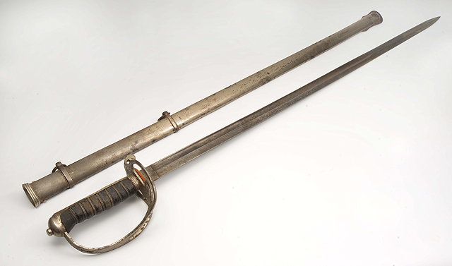 Appraisal: AN EDWARDIAN OFFICER'S SWORD with etched blade scrolling guard snake