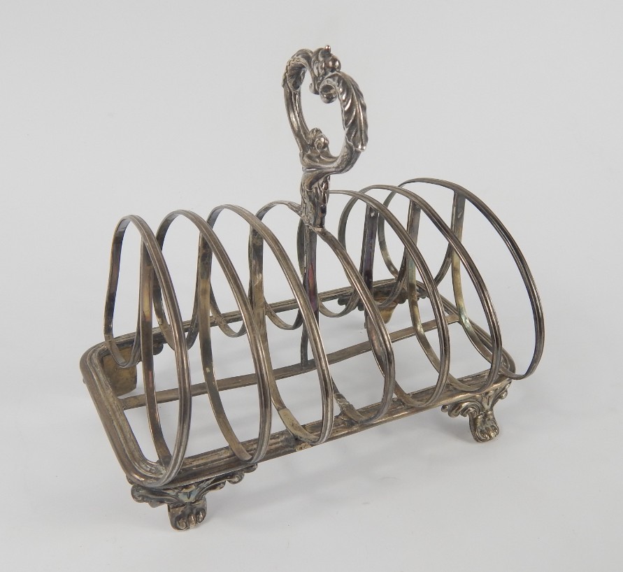 Appraisal: A Victorian silver six division toast rack raised on leaf