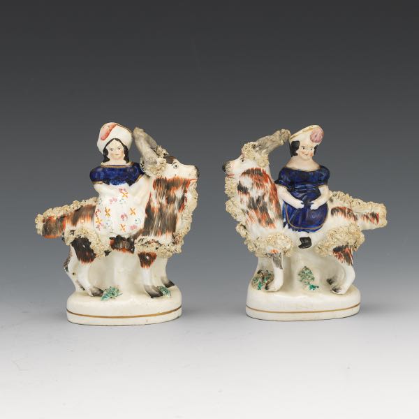 Appraisal: PAIR OF STAFFORDSHIRE GIRL RIDING A GOAT FIGURINES x Antique