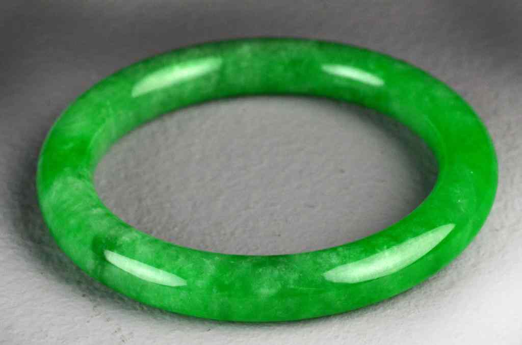 Appraisal: Chinese Apple Green Jadeite Bangle BraceletUncarved with very fine polish