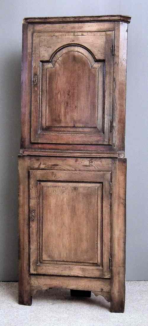 Appraisal: An th Century oak and fruitwood two tier corner cupboard