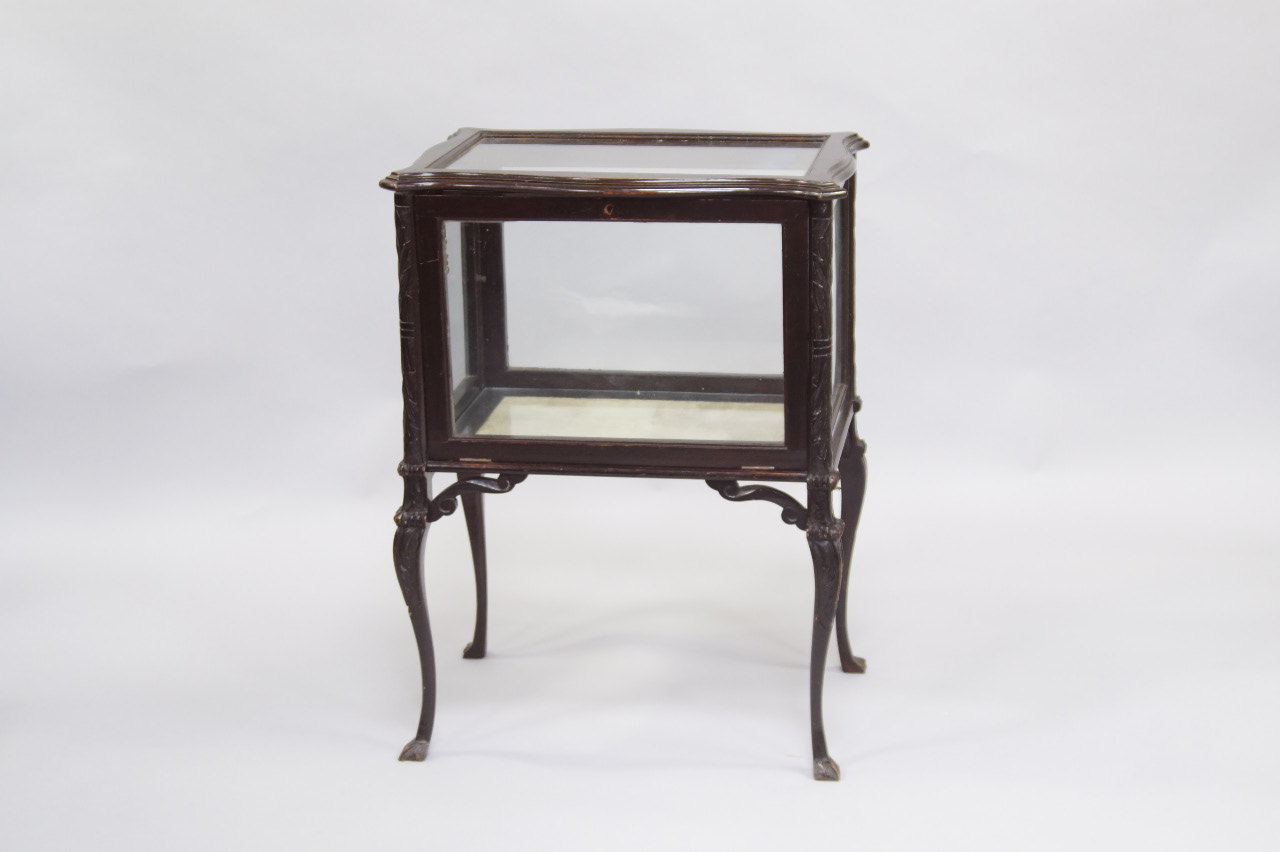 Appraisal: A Victorian ebonised bijouterie table of serpentine form raised on