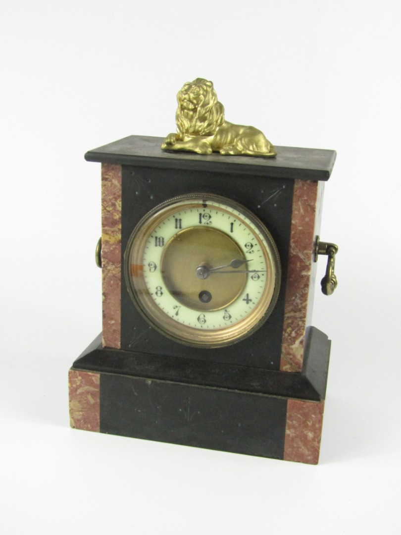 Appraisal: A Victorian slate and marble mantel clock with recumbent lion