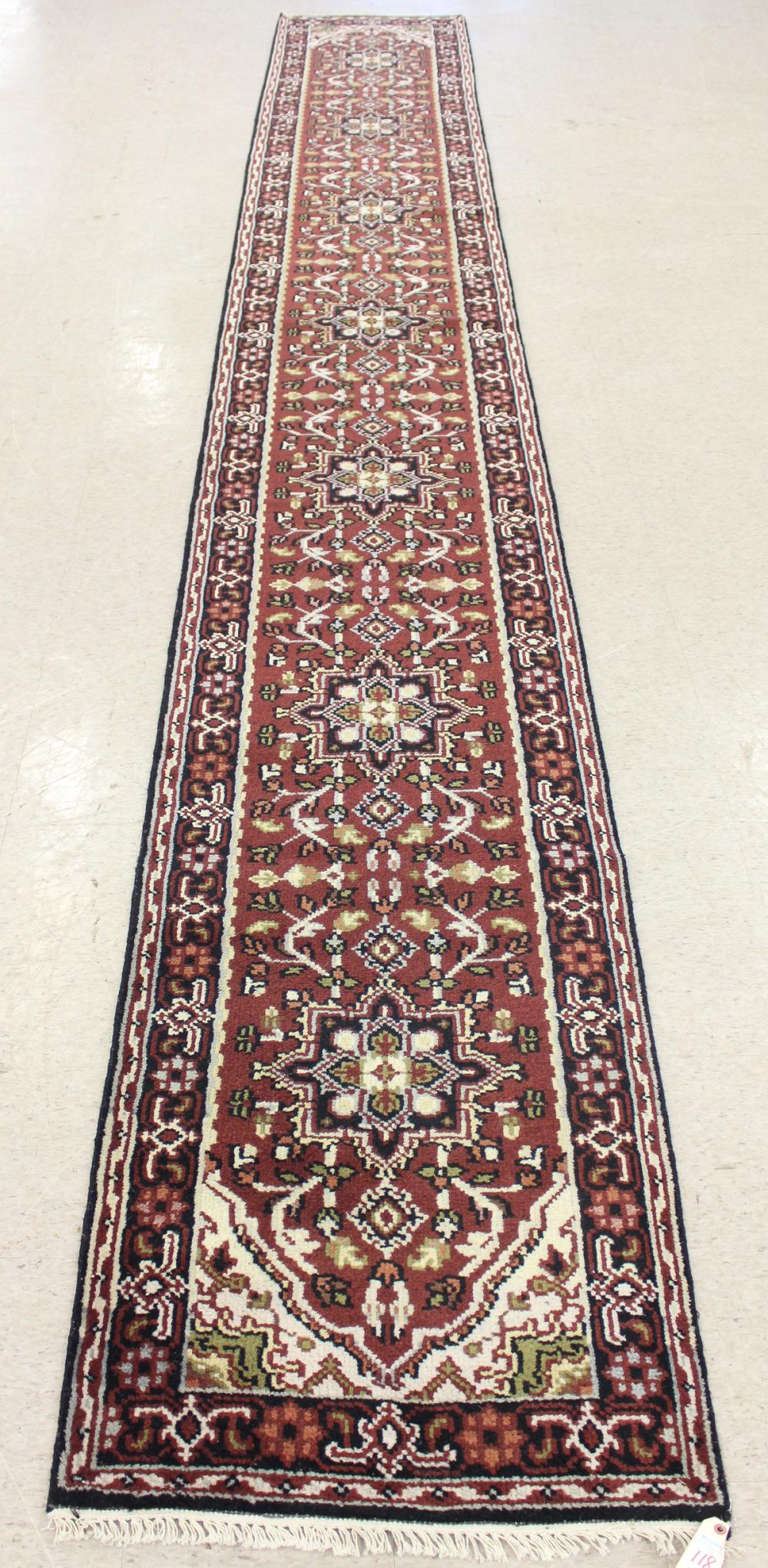 Appraisal: HAND KNOTTED ORIENTAL RUNNER Indo-Persian seven geometric medallions and stylized