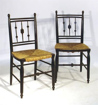 Appraisal: Four ebonised wood rush seated Sussex chairs in the manner