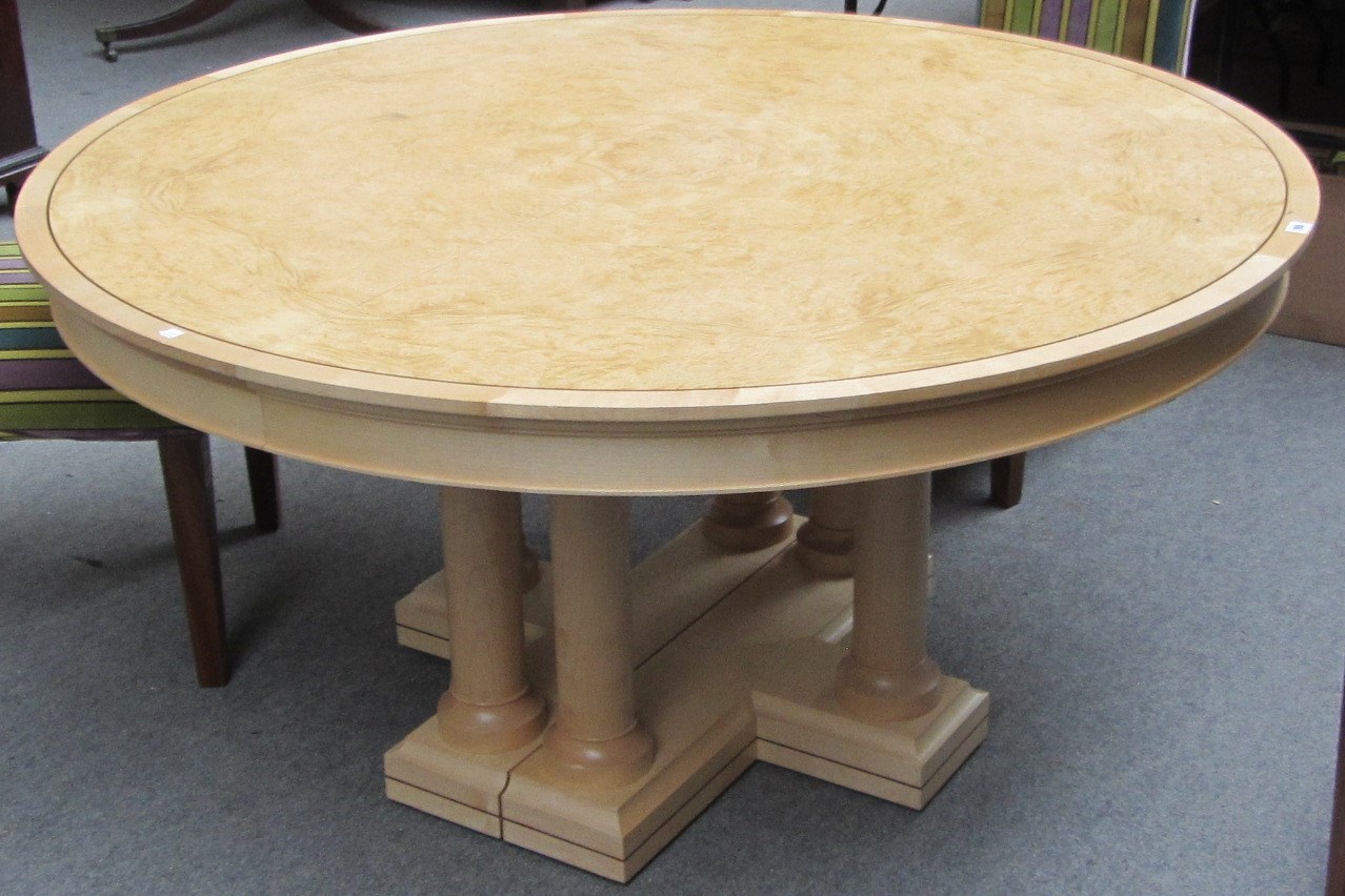 Appraisal: A th century burr ash circular extending dining table on