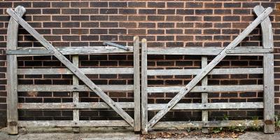 Appraisal: A pair of five-bar cranked teak gates with curved hook