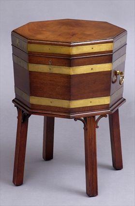 Appraisal: GEORGE III-STYLE BRASS-MOUNTED MAHOGANY OCTAGONAL CELLARET The hinged top opening