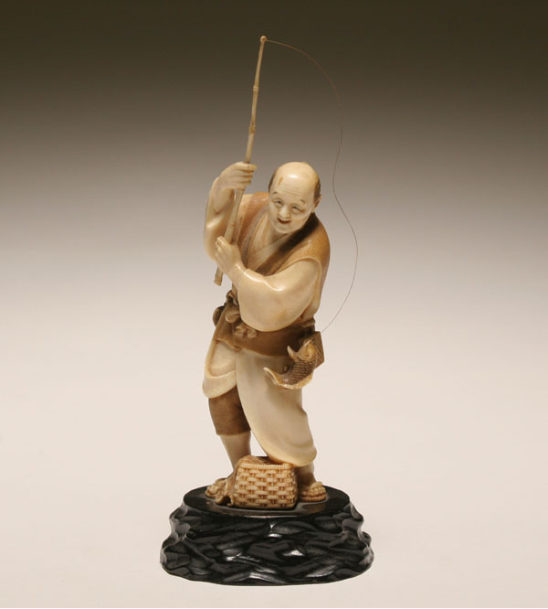 Appraisal: Japanese carved ivory figure of a fisherman reeling in a