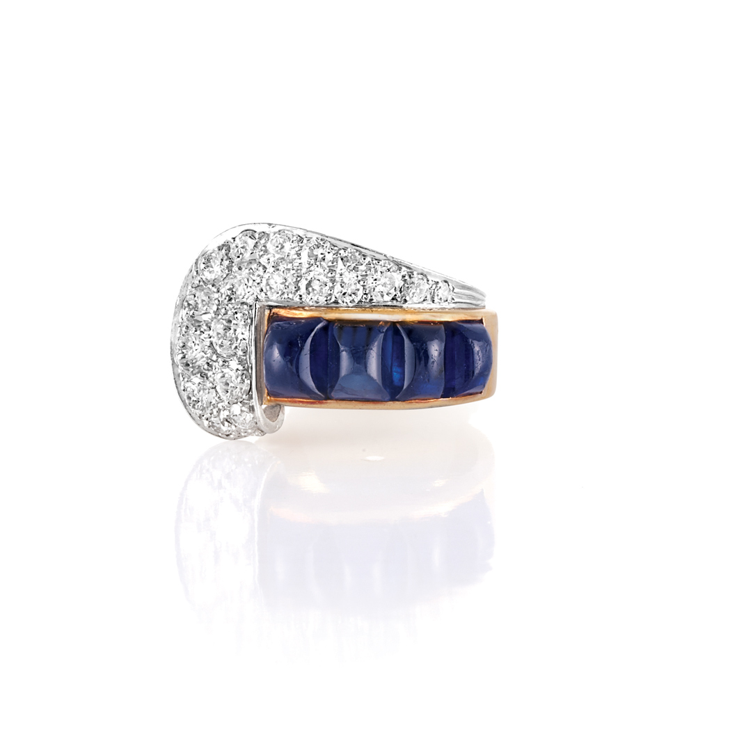 Appraisal: Gold Platinum Cabochon Sapphire and Diamond Ring The stylized buckle