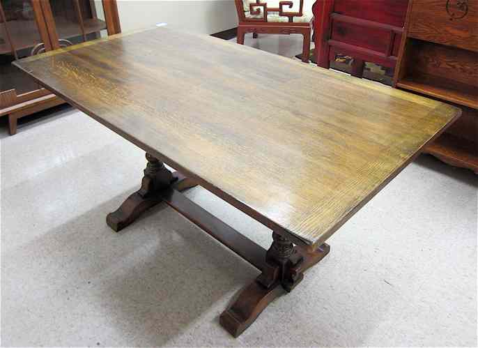 Appraisal: AN OAK TRESTLE DINING TABLE Ebenezer Gomme Furniture Co High