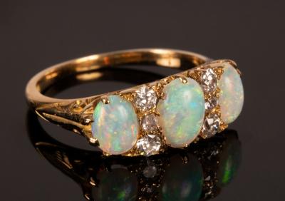 Appraisal: An opal three-stone ring the oval opals interspersed by two