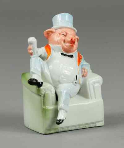 Appraisal: SEATED PIG IN SUIT STILL BANK Porcelain well painted overall