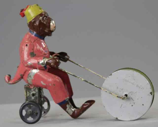 Appraisal: MONKEY PUSHING BELL DRUM Germany hand painted monkey riding open