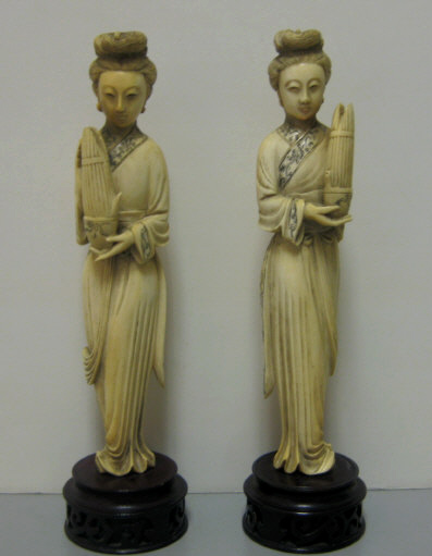 Appraisal: PAIR CHINESE CARVED IVORY FEMALE FIGURES Each standing with flowing