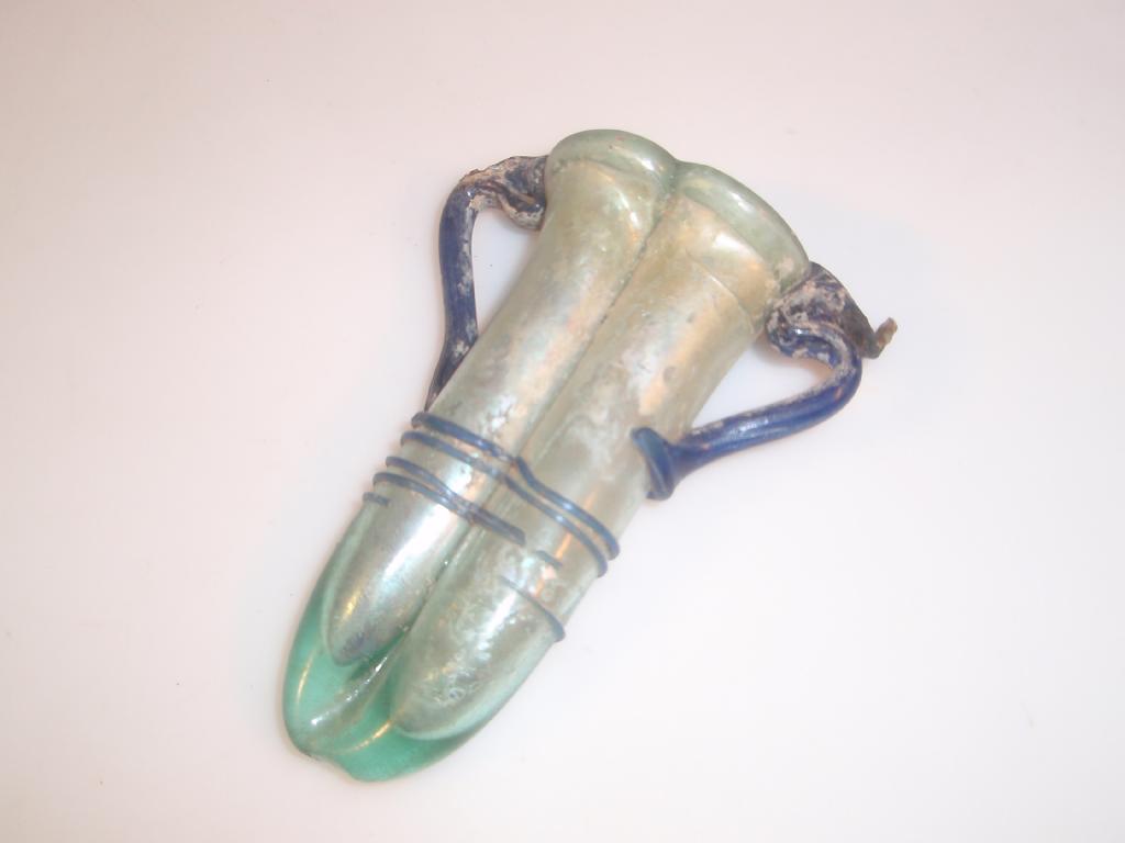 Appraisal: A Roman bluish-green double-bodied glass balsamarium with a folded hollow-tubular