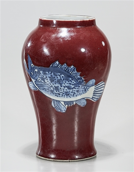 Appraisal: Chinese oxblood porcelain vase with blue and white fish motif