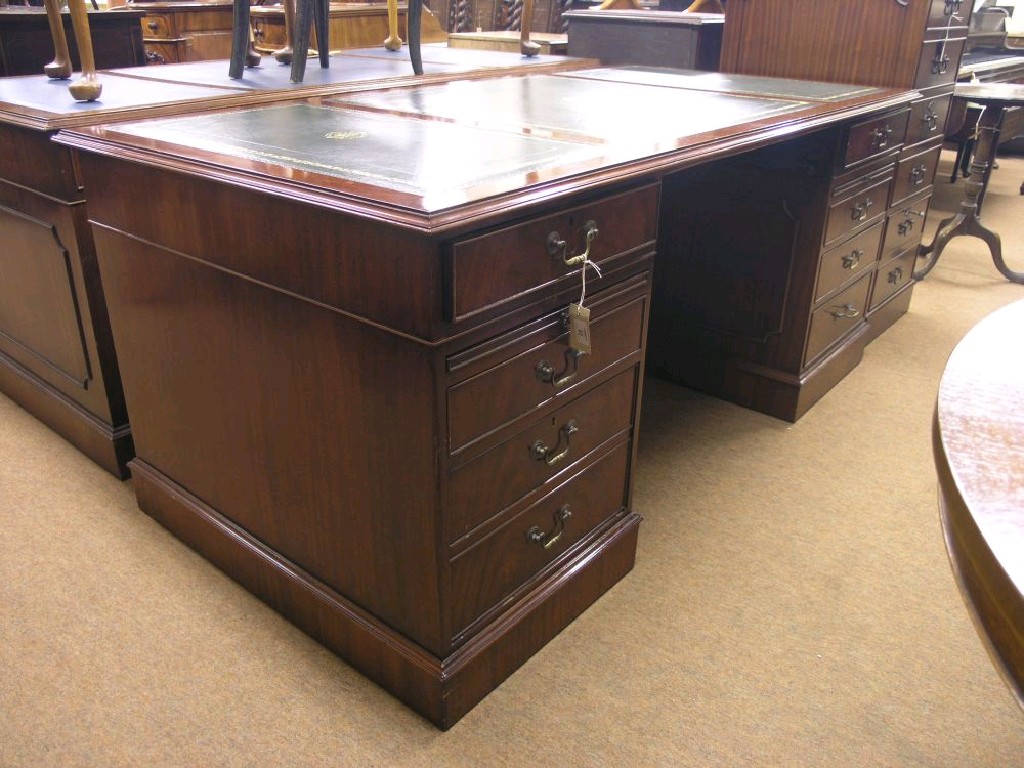 Appraisal: A reproduction mahogany pedestal desk inset gilt-tooled green leather top