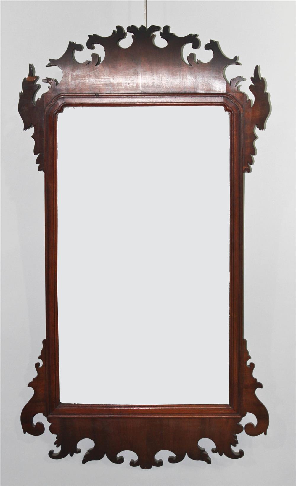 Appraisal: CHIPPENDALE MAHOGANY MIRROR the scroll cut crest over an old