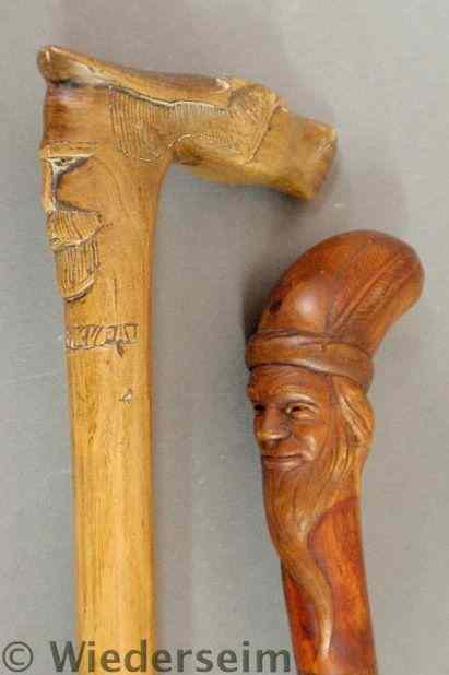 Appraisal: Two carved walking sticks late th c one with a