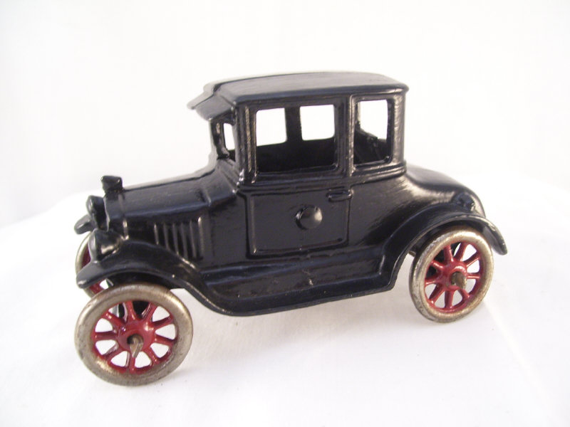 Appraisal: Cast Iron Car Original black paint white rubber wheels Measures