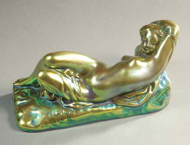 Appraisal: ZSOLNAY EOSIN LUSTRE PORCELAIN FIGURINE of a reclining nude female