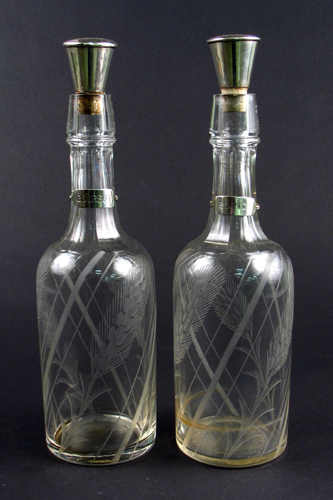 Appraisal: PAIR OF CUT CRYSTAL WHISKEY DECANTERS with Sterling Silver stoppers