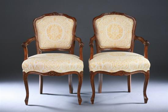 Appraisal: PAIR LOUIS XV STYLE PROVINCIAL FRUITWOOD FAUTEUILS th century with