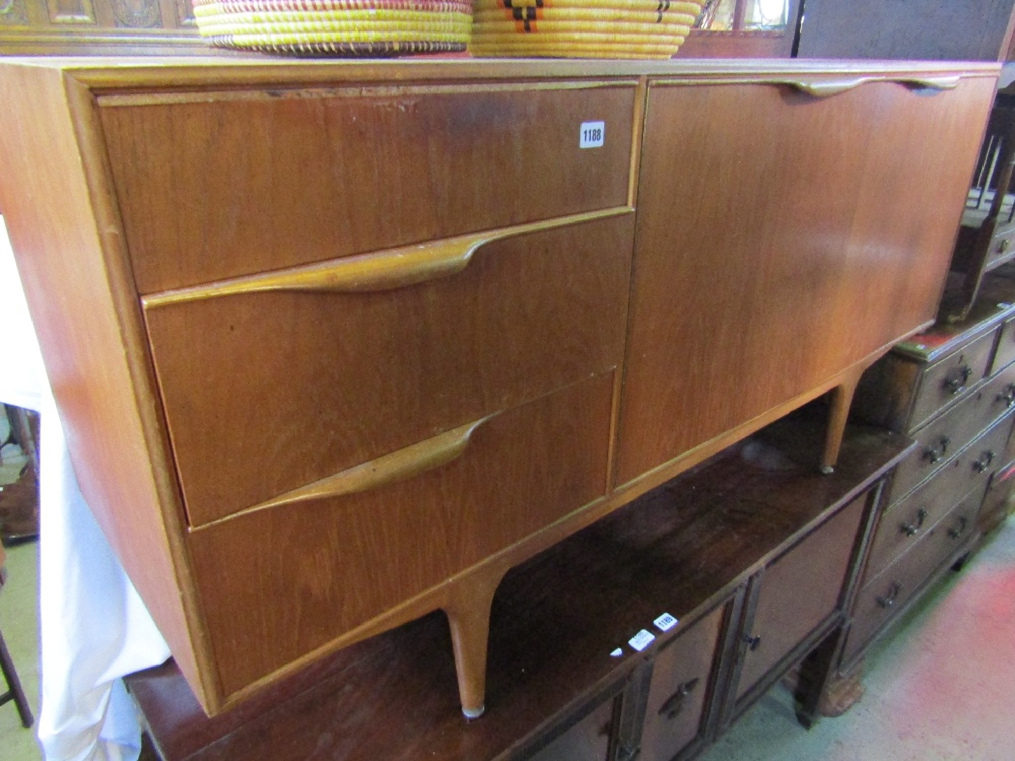 Appraisal: A mid th century teak sideboard by A H Mackintosh