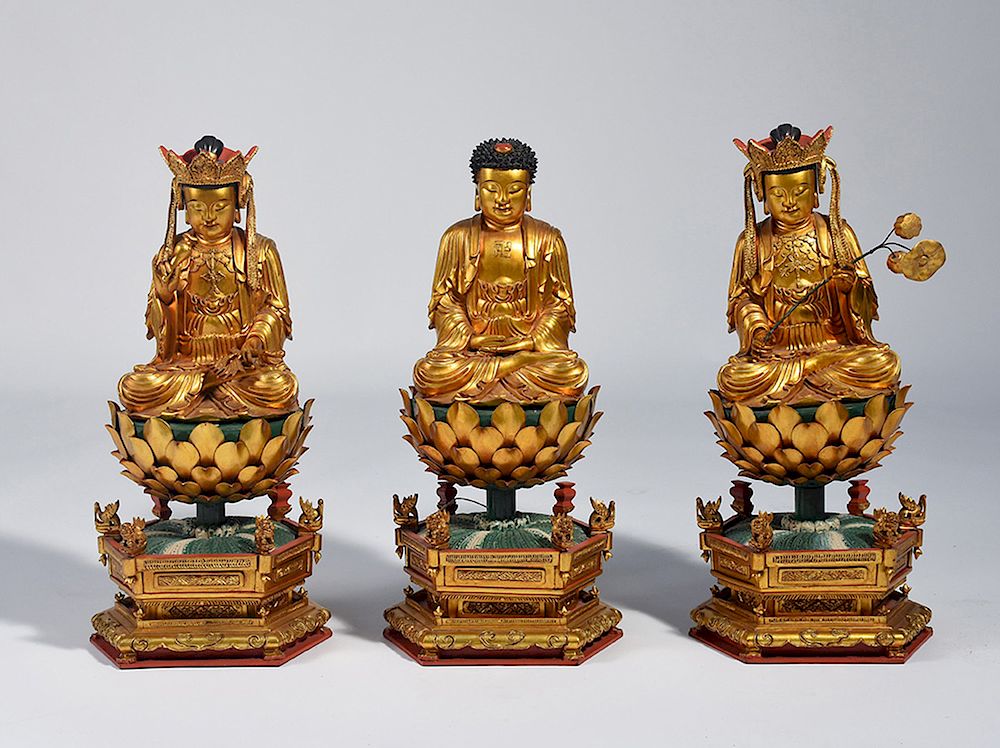 Appraisal: Three Chinese carved and gilt wood Buddhas Three Chinese carved