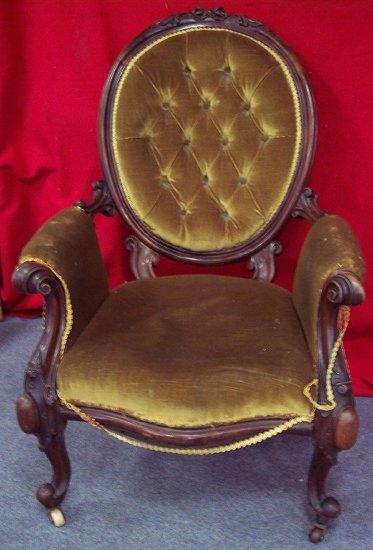 Appraisal: A Victorian walnut framed fireside chair the oval button back