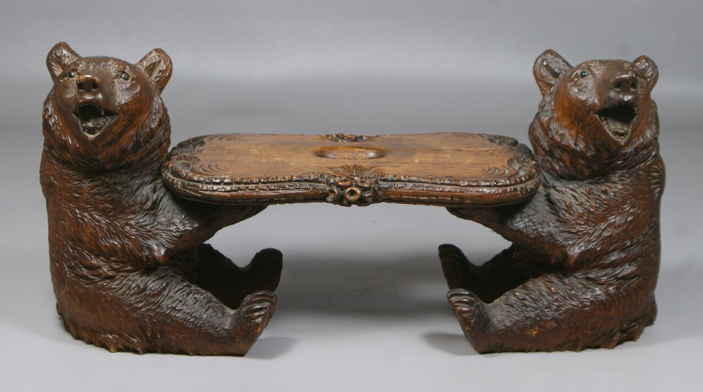 Appraisal: Carved Black Forest desk stand bears holding a shelf w