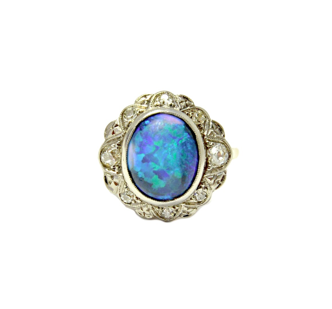 Appraisal: A gold and platinum opal and diamond set oval cluster