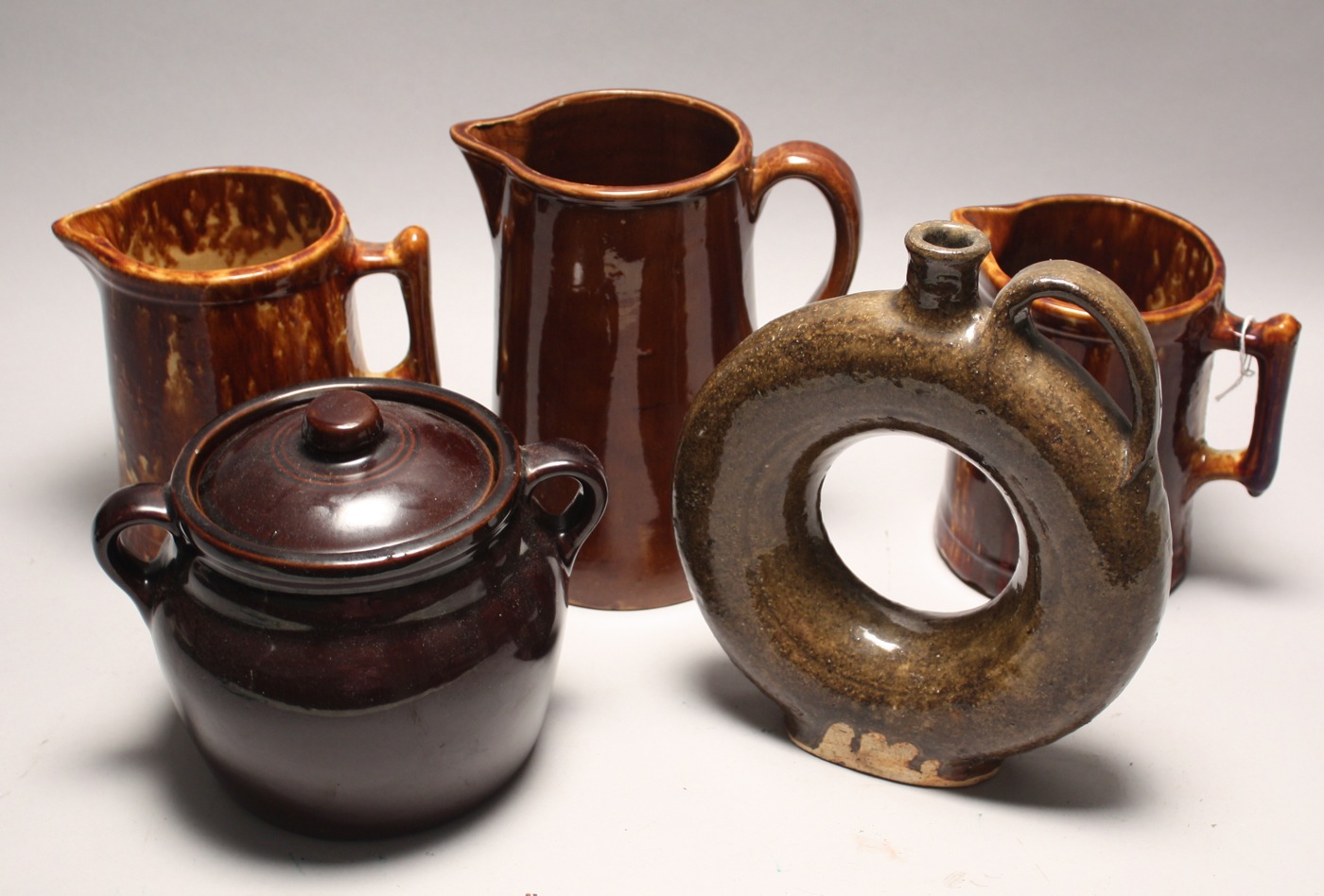 Appraisal: FIVE BROWN-GLAZE EARTHENWARE PITCHERS JUGS AND CROCKS Late th Early