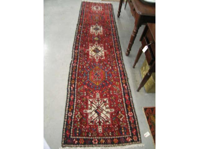 Appraisal: Heriz Persian Handmade Runner geometric medallions reds blues ivory '